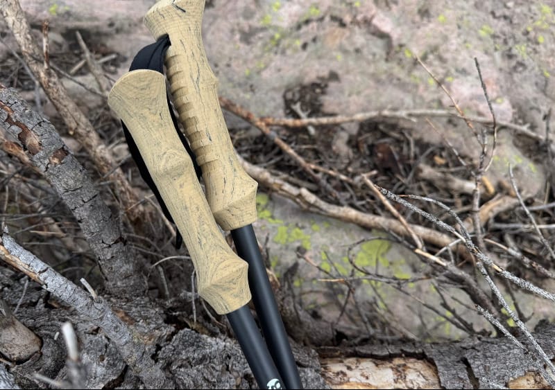 Detail shot of Gossamer Gear trekking pole grips resting on tree bark.