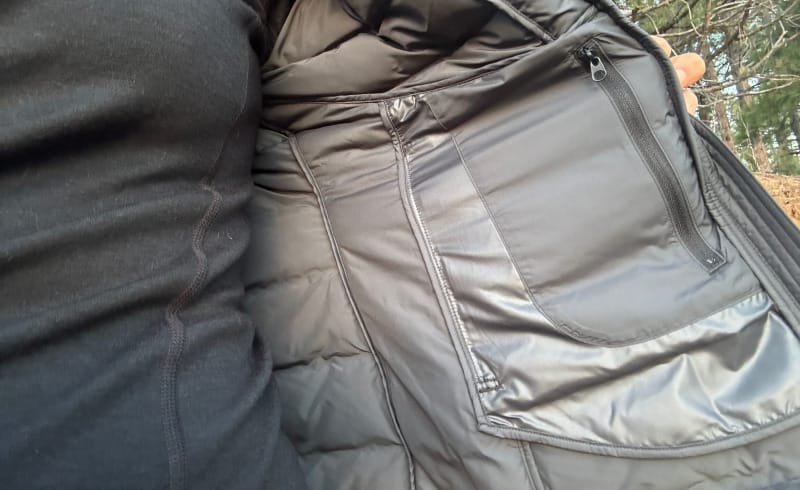 Close-up of inside zip pocket and lining of KUIU Elements Hooded Jacket, photographed outdoors in natural light.