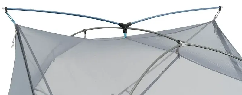 Backpacker setting up the Sea to Summit Telos Freestanding Ultralight Tent using its simple pole structure on rocky terrain.