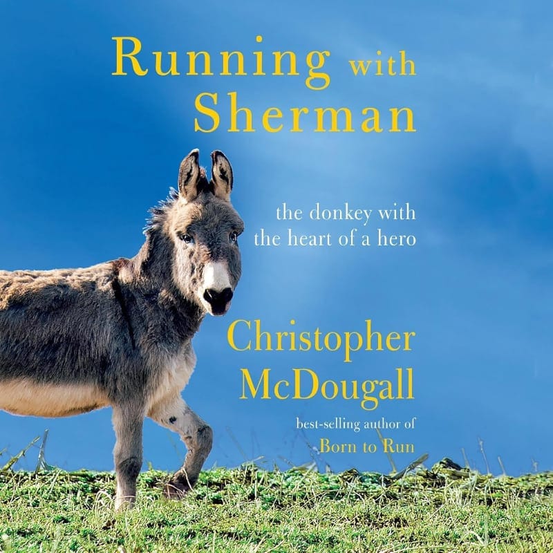 Book cover of Running with Sherman by Christopher McDougall, featuring a donkey walking through green grass under a bright blue sky.
