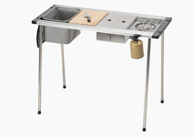 Snow Peak camping kitchen table with sink, cutting board, and stove — premium camp kitchen gear for outdoor enthusiasts 2025.
