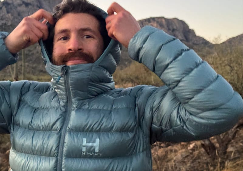 Himali Accelerator Down Jacket with hood up showing athletic fit and lightweight down insulation