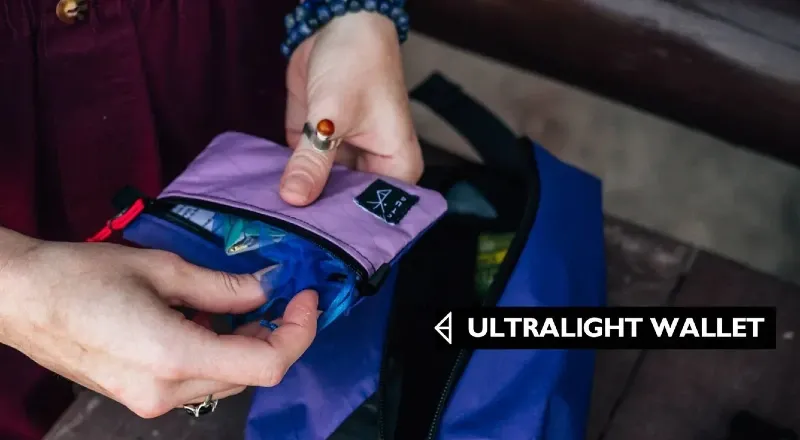 Hands holding an ultralight wallet by Chicken Tramper Ultralight Gear, showing a minimalist design made for backpacking and hiking.