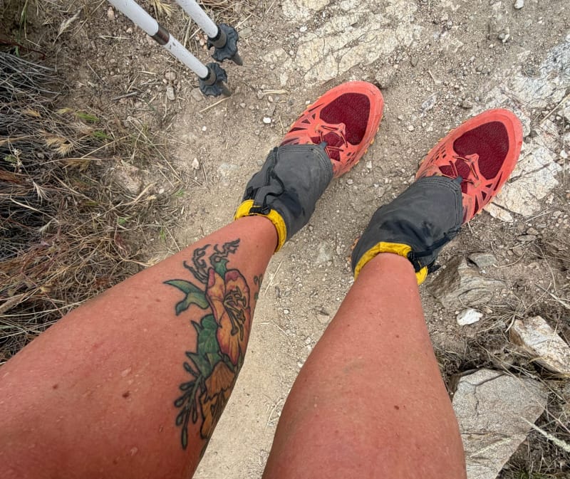 La Sportiva Bushido III trail running shoes worn with gaiters and trekking poles on dirt hiking trail