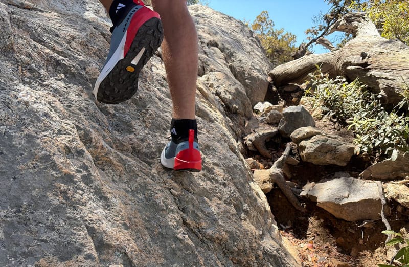 Close-up of Mammut Aenergy Trail Speed shoes gripping steep granite terrain during a mountain hike.