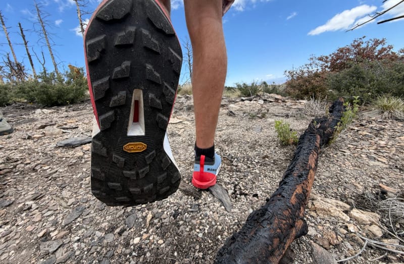 Close-up of the outsole of the Mammut Aenergy Trail Speed hiking shoe while hiking on a rocky mountain trail.