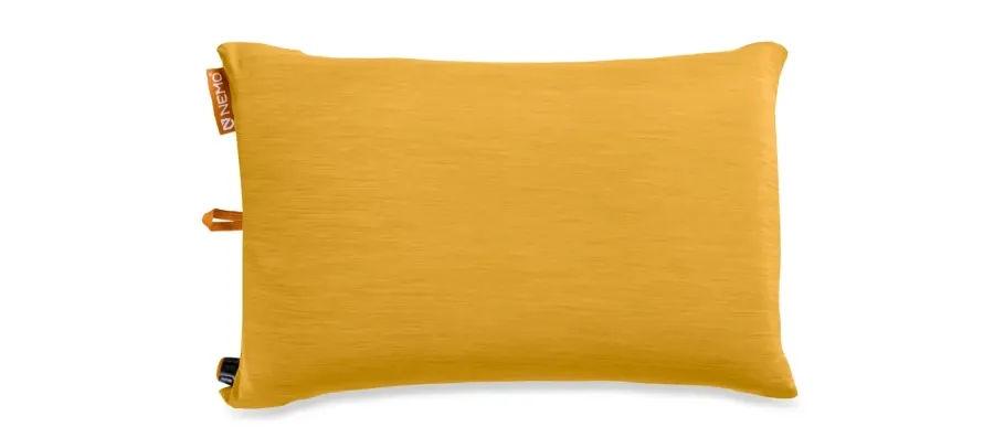 Mustard yellow NEMO Fillo inflatable camping pillow with rectangular shape, fabric cover, orange NEMO label, and inflation valve.