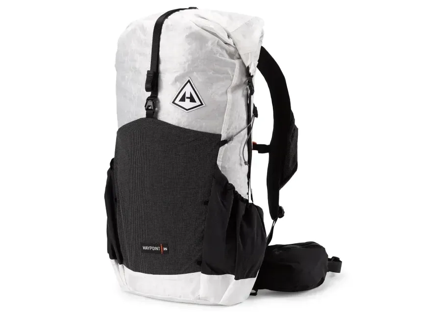 White Hyperlite Mountain Gear Waypoint 35 ultralight backpack with black exterior pockets, roll-top closure, shoulder straps, and hip belt.