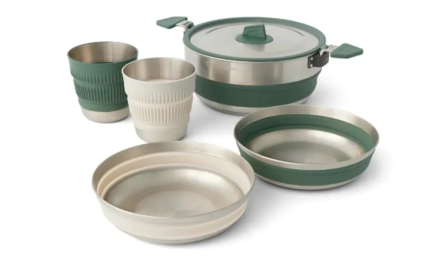 Sea to Summit Detour collapsible camp cooking set featuring a stainless steel pot, two bowls, and two cups with green and cream silicone accents.