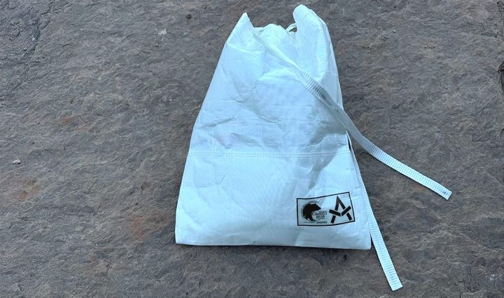 Grizzly Bear Resistant Ultralight Food Locker By Adotec Gear sitting on a rock in canyon country, full of food. updated for 2025