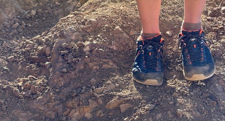 a hiker wears the Alnasca Knit III Low GTX Shoe By Mammut on sketchy terrain