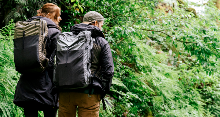 two explorers wear ADC Travel Pack by six moon designs in the jungle on a trip
