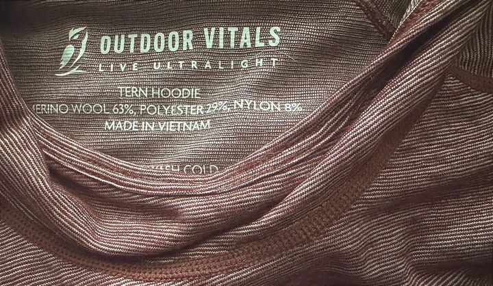 Close-up of the Tern Hoodie by Outdoor Vitals showing the interior label and wool-polyester fabric blend.