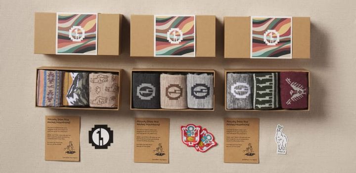  Flat lay of PAKA’s 3-Pack Sock Gift Boxes showing three different sets of alpaca socks, each with custom packaging, stickers, and “Made in the Andes” cards.