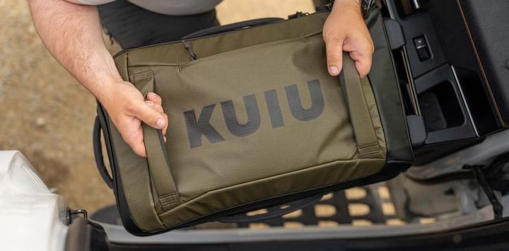 Hiker using KUIU camouflage gear and backpacking gear in the mountains during KUIU’s 2025 Biggest Sale of the Year, offering up to 50% off and free shipping over $149.