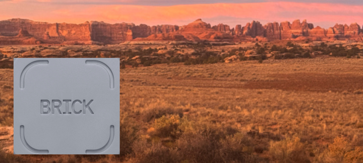 Mountain trail through red rock canyons on a clear day, symbolizing distraction-free hiking and digital detox adventures featuring the use of Brick.