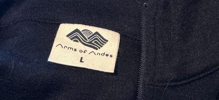 Arms of Andes Alpaca Wool Base Layer photographed in natural outdoor light, representing sustainable alpaca wool clothing made ethically in Peru.