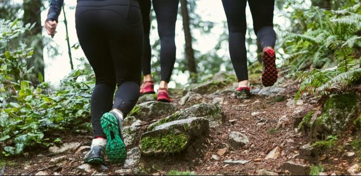 Outdoor flatlay of hiking and backpacking gear from women-led outdoor brands for 2025.