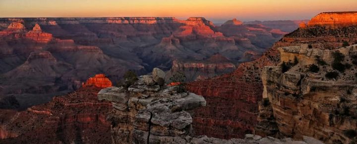 grand canyon national park at dawn national park landscape with sandstone cliffs under blue sky, representing gifts for national park lovers.