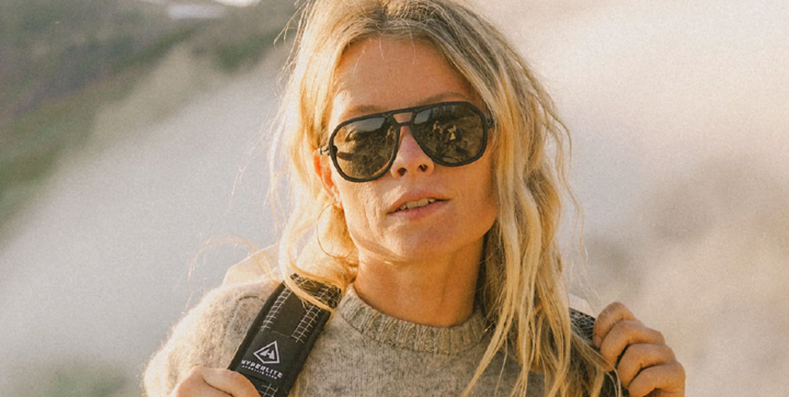 woman wearing ombraz to celebrate the Ombraz Black Friday and Cyber Monday Sale 2025 while she is backpacking.