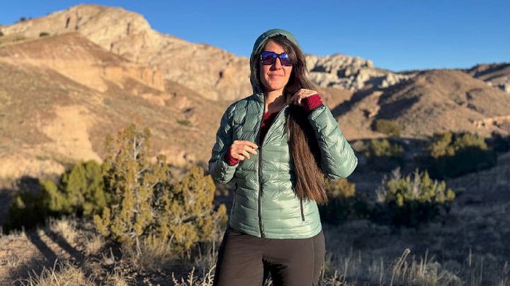 Outdoor Vitals NovaPro Down Jacket worn by a hiker in desert mountains, showcasing lightweight insulation and fit for backpacking and outdoor adventures