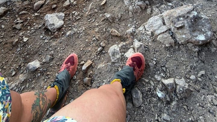 Close-up of La Sportiva Bushido III shoes on rocky trail surface showing traction and terrain detail