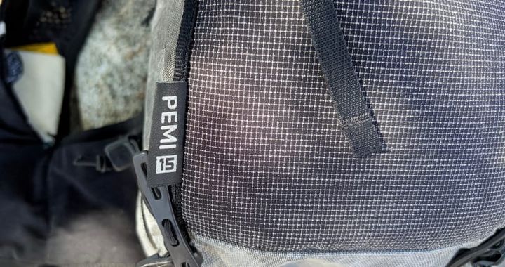 Detailed close-up of the Hyperlite Mountain Gear Pemi 15 Dyneema fabric and zipper pull on the ultralight backpack.