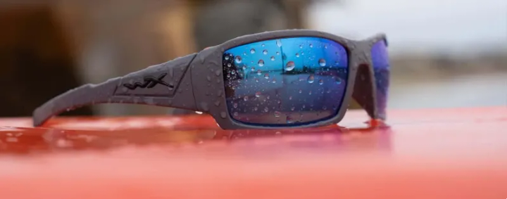  Person wearing Wiley X outdoor sunglasses while hiking in rugged desert terrain during morning hours.