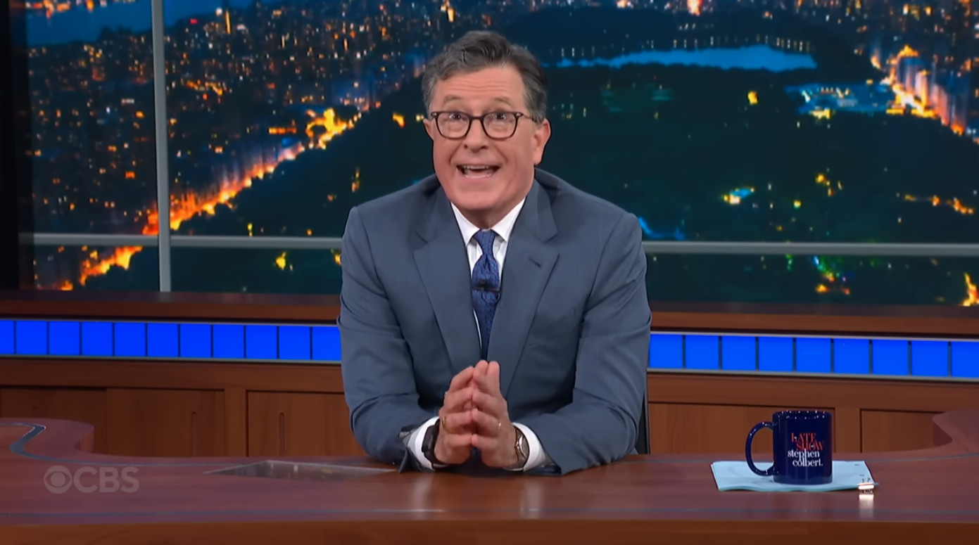 Stephen Colbert soaking in the audience's boos after he announced the cancellation of the Late Show.