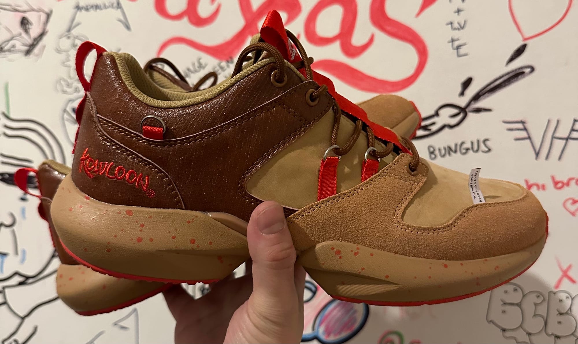 Brown and red Kowloon sneakers. The fortune on the toe says: You will have fresh kicks today.