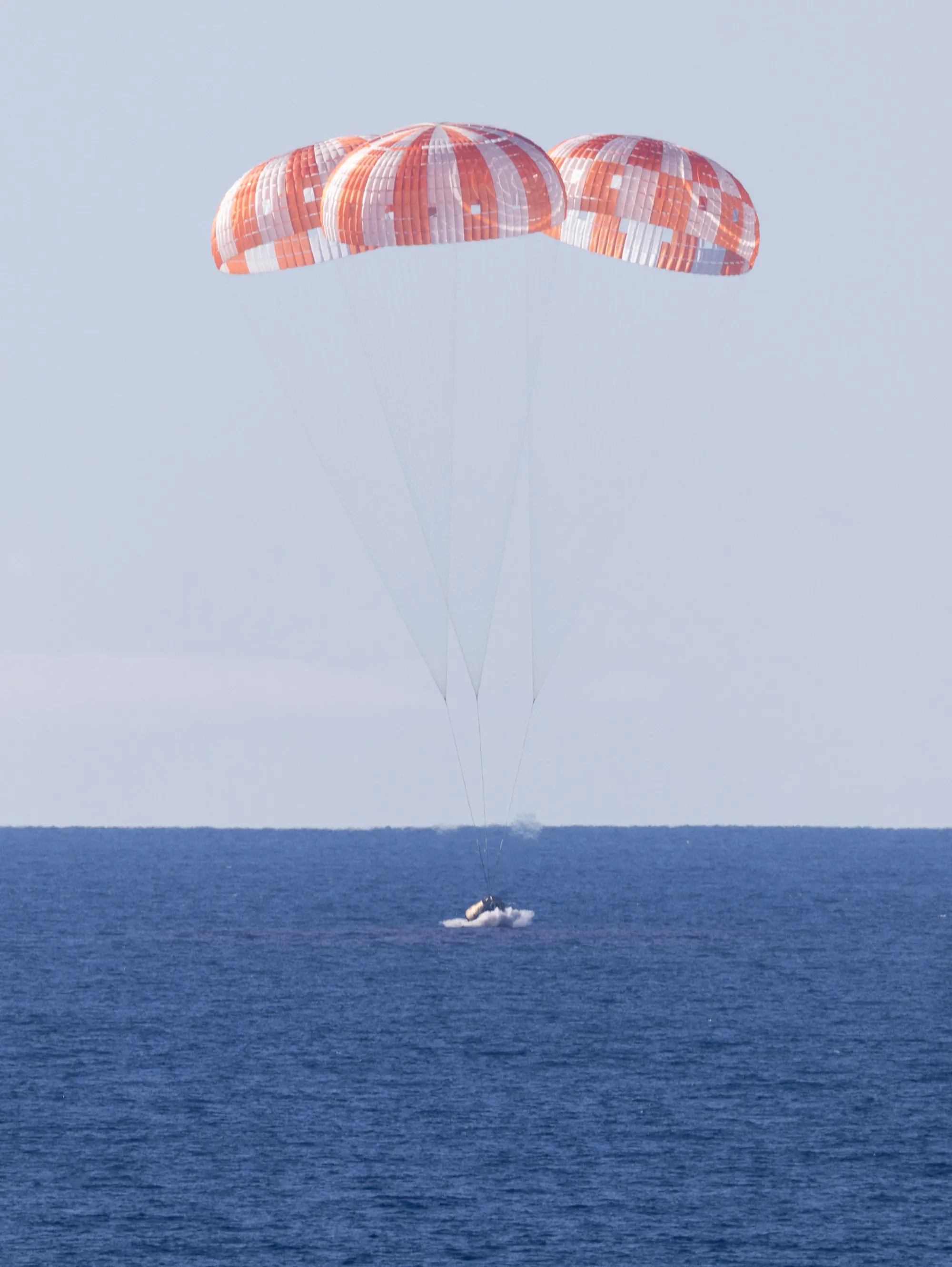 Astronaut parachuting into the ocean near San Diego.