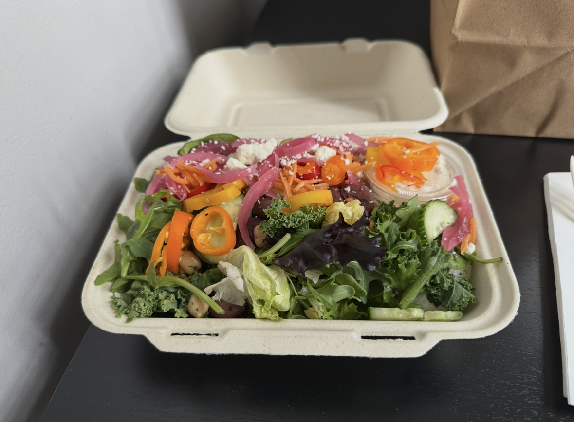 A vibrant salad in a to-go container, as described elsewhere.
