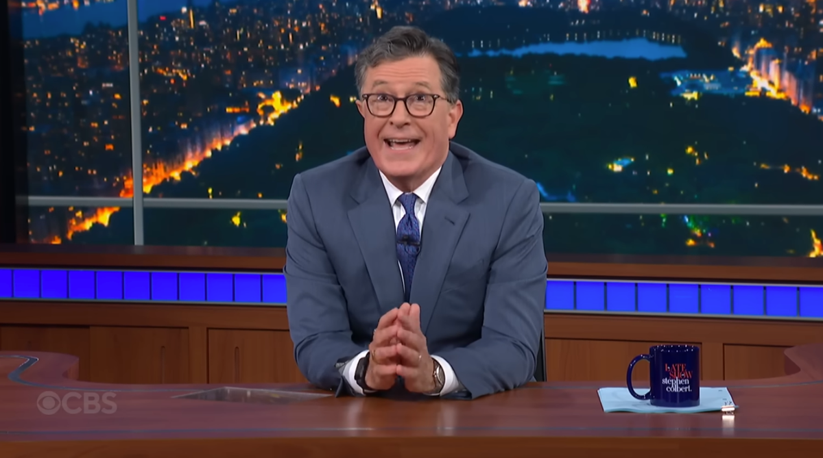 Stephen Colbert soaking in the audience's boos after he announced the cancellation of the Late Show.