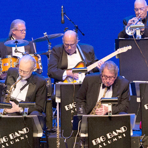 big band in tuxedos at music stands playing instruments