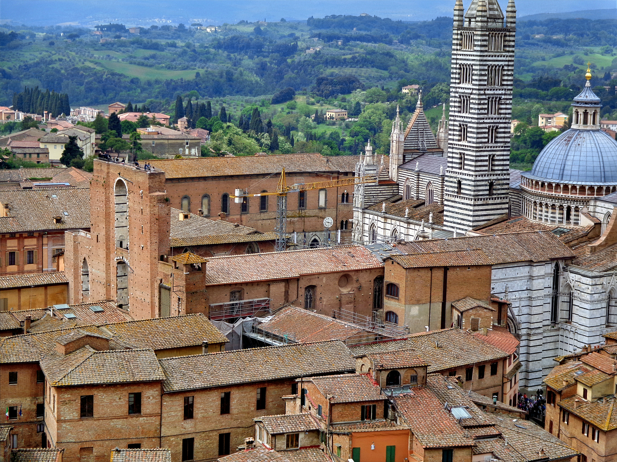 A panoramic view of the Facciatone looking at the completed polychrome dome and bell tower of the Siena Cathedral.