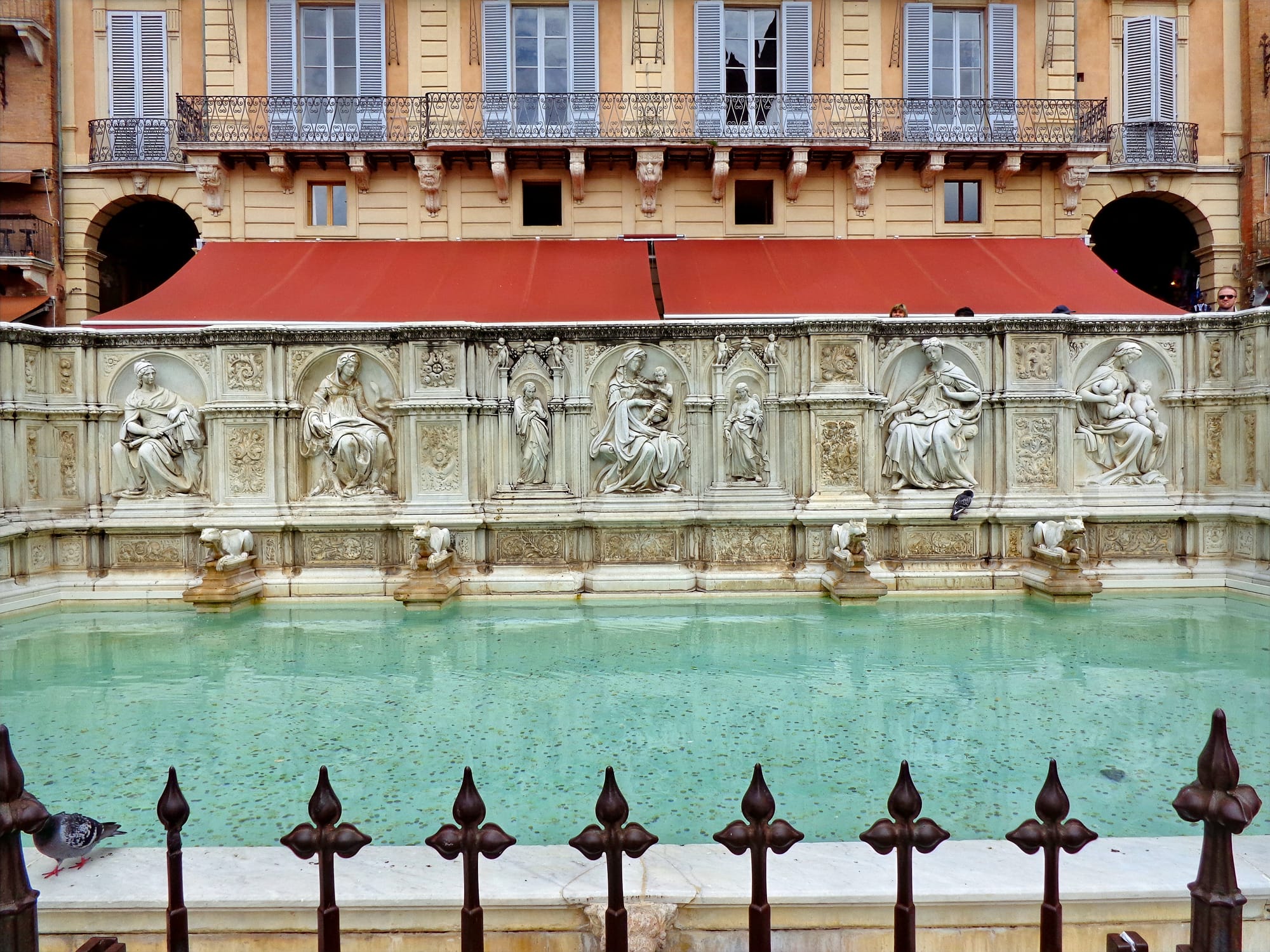 The white marble monumental basin of Fonte Gaia located on the upper side of Piazza del Campo.