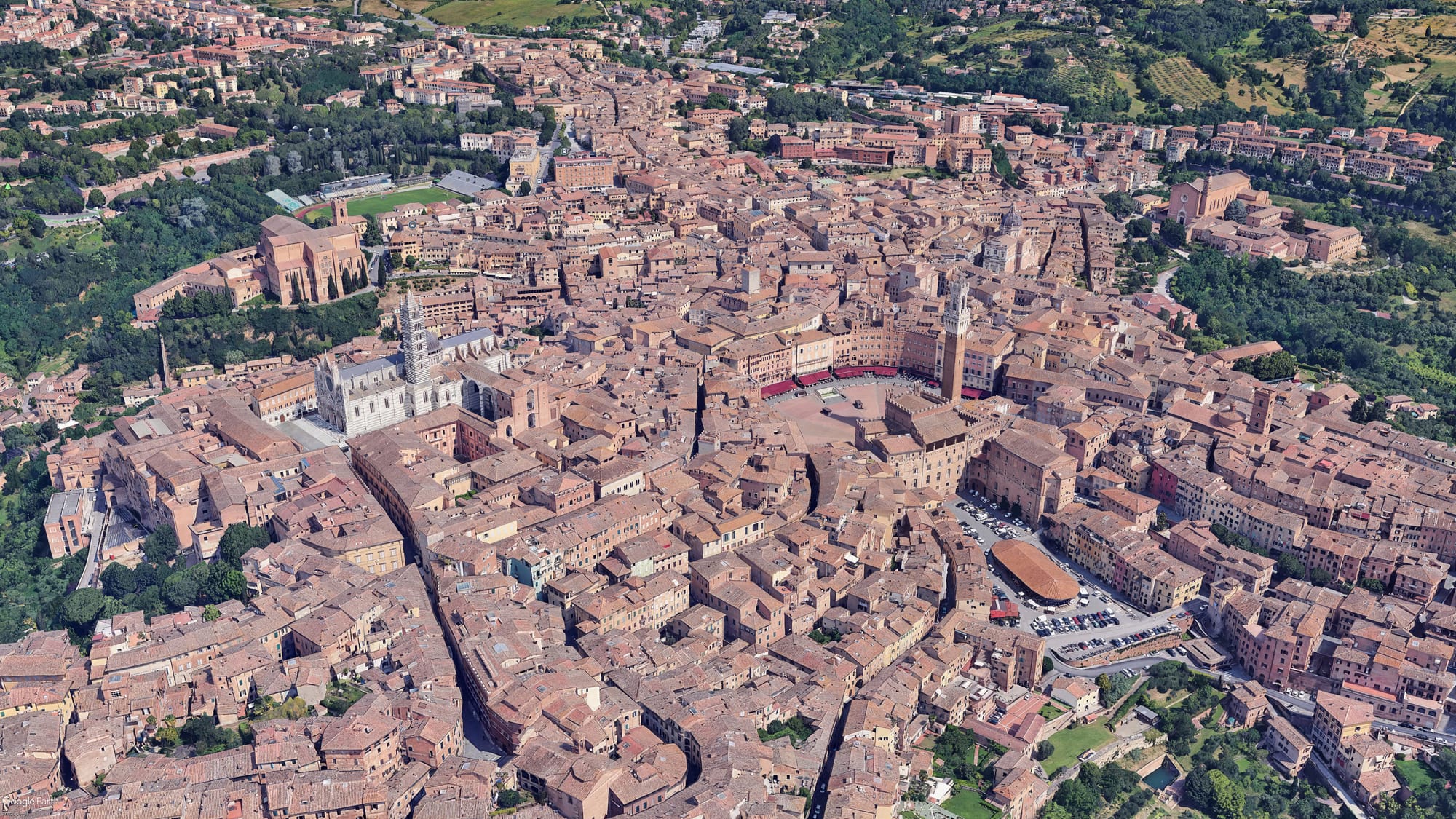 Aerial view of Siena showing the Y-shaped structure of the three medieval hills converging toward Piazza del Campo.