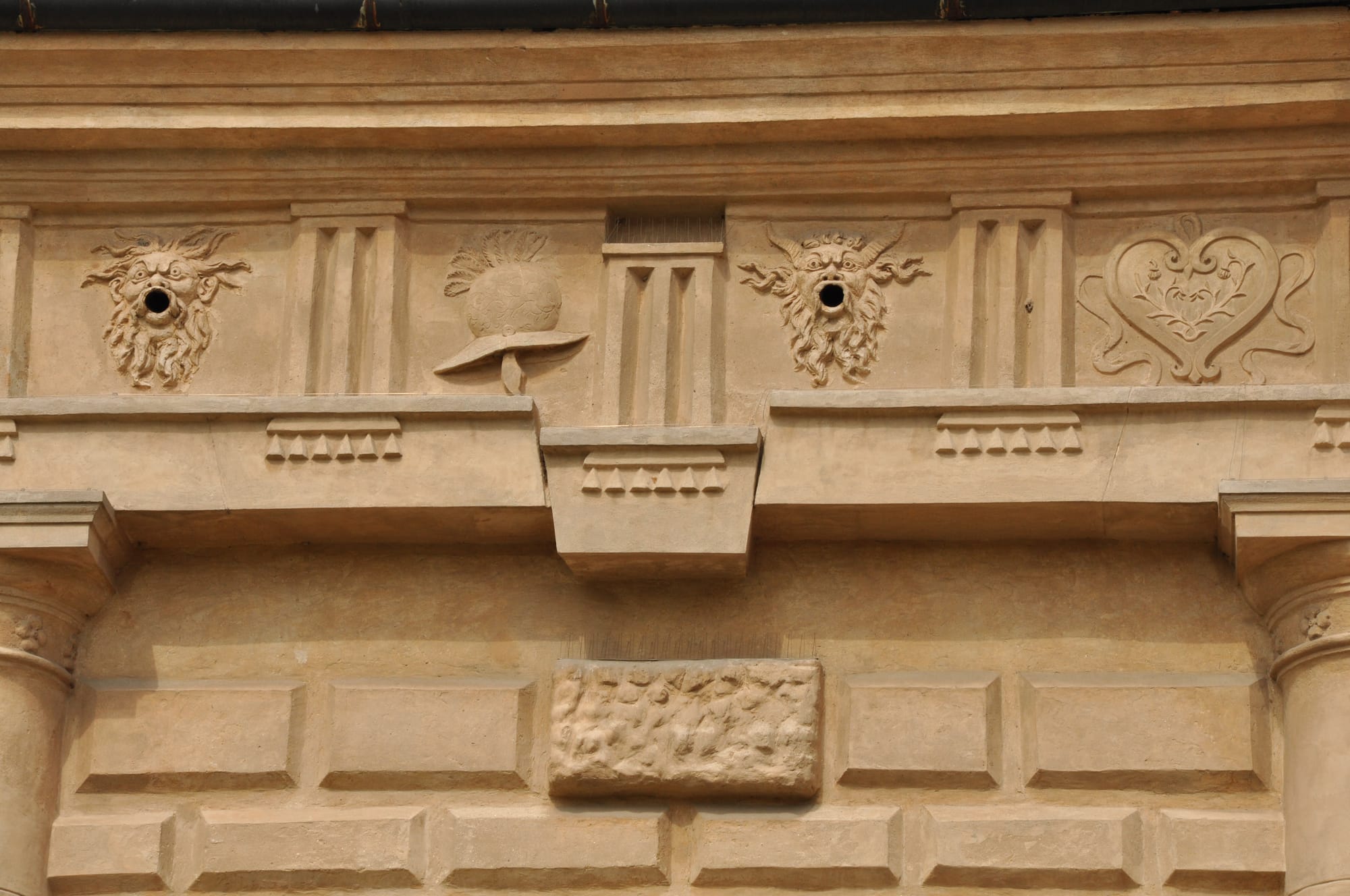 Close-up of the Doric frieze showing a central triglyph that has slipped downward out of the horizontal entablature line.