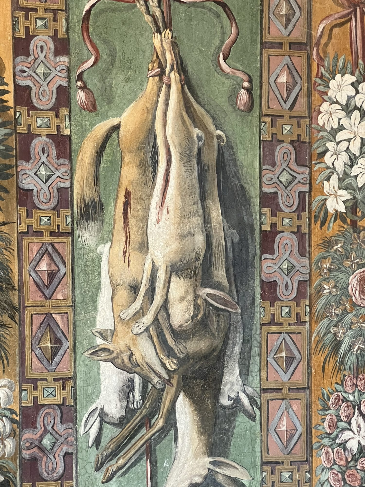 Hanging game painted in trompe-l'oeil between two decorative bands with geometric patterns and flowers