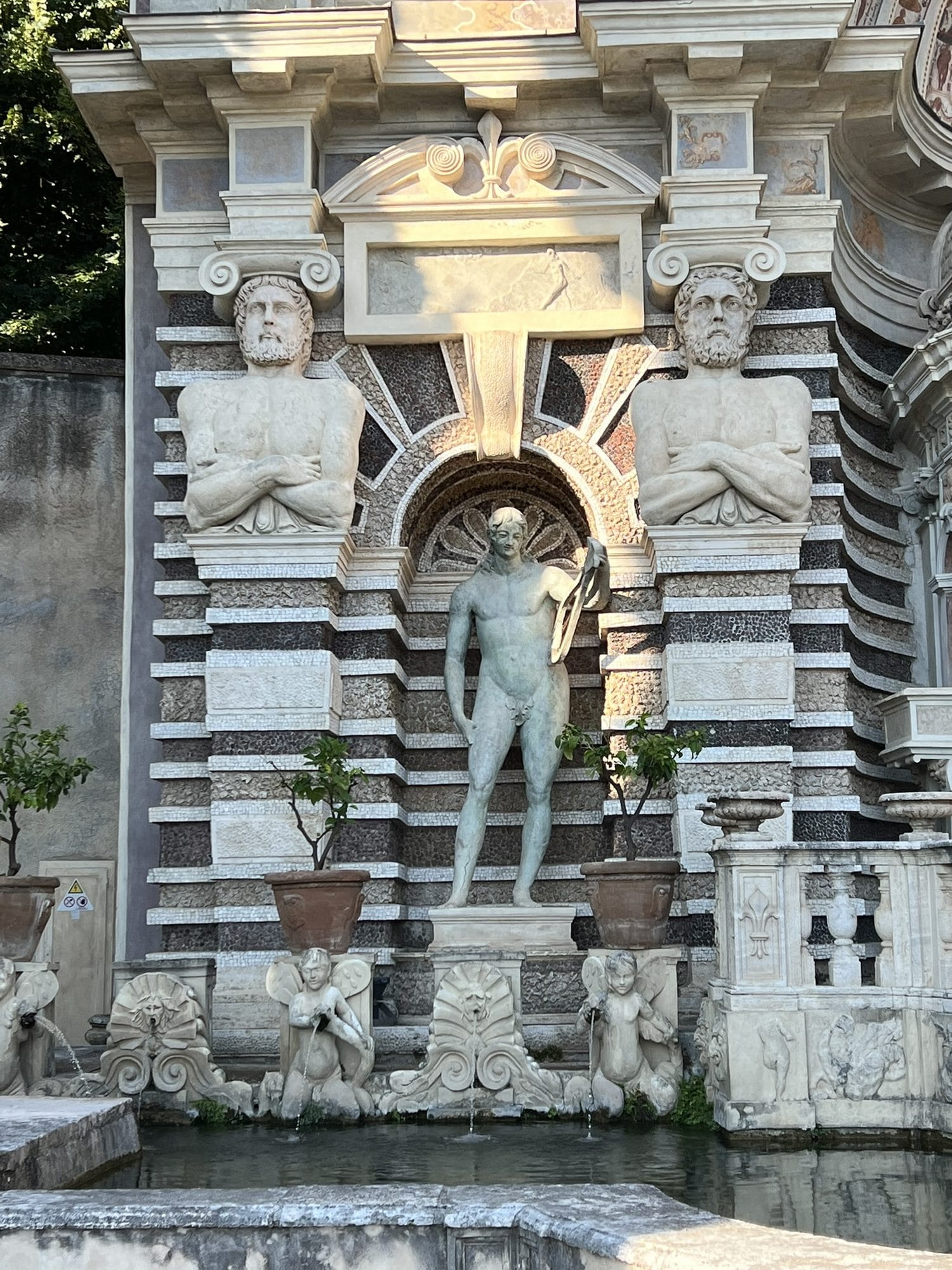 Niche with a statue of a male nude between two telamons, on the banded façade of the Fountain of the Organ