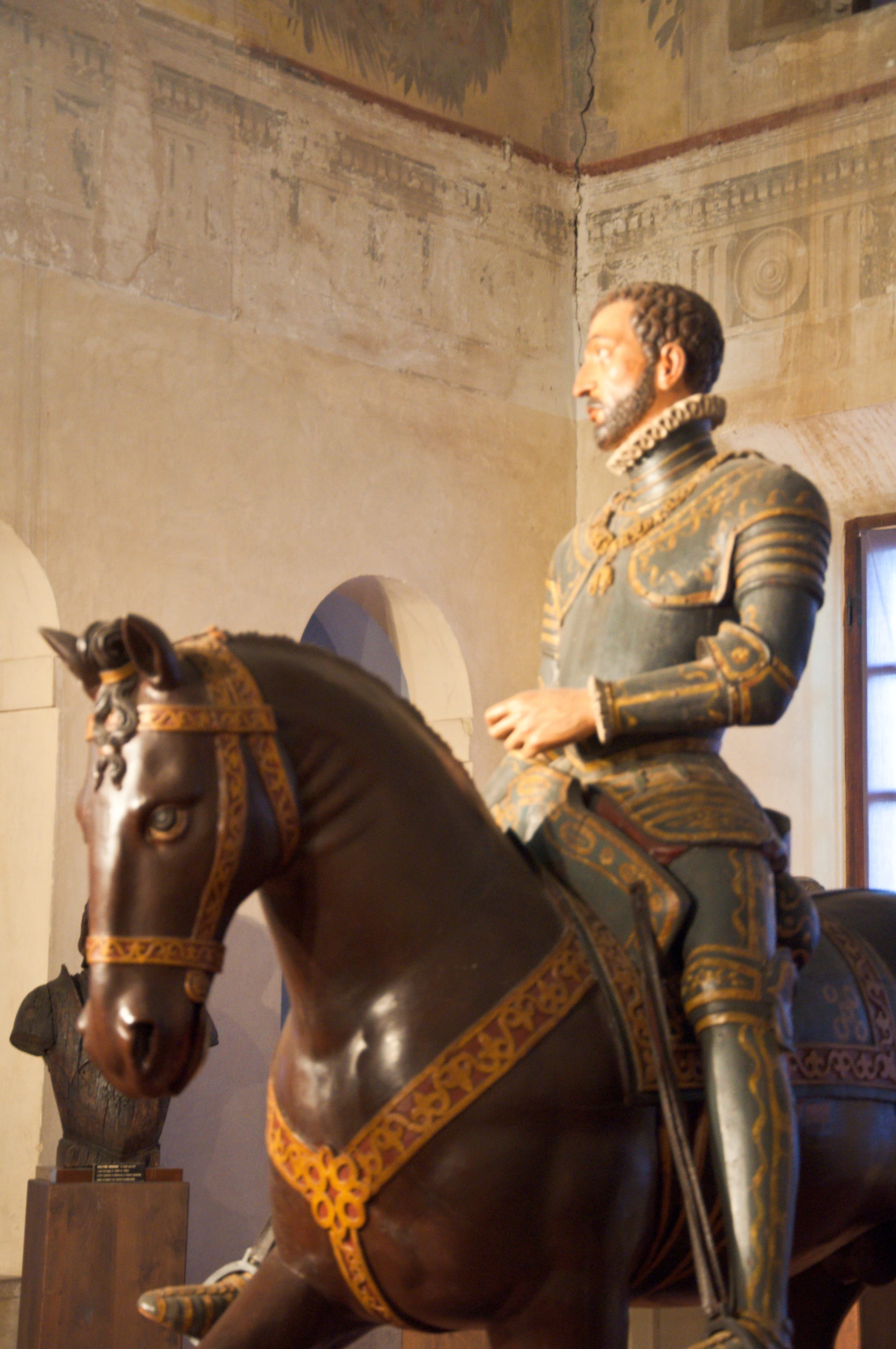 Painted wooden equestrian statue of a Gonzaga in armour with a ruff collar, in a frescoed room of the Ducal Palace, Sabbioneta