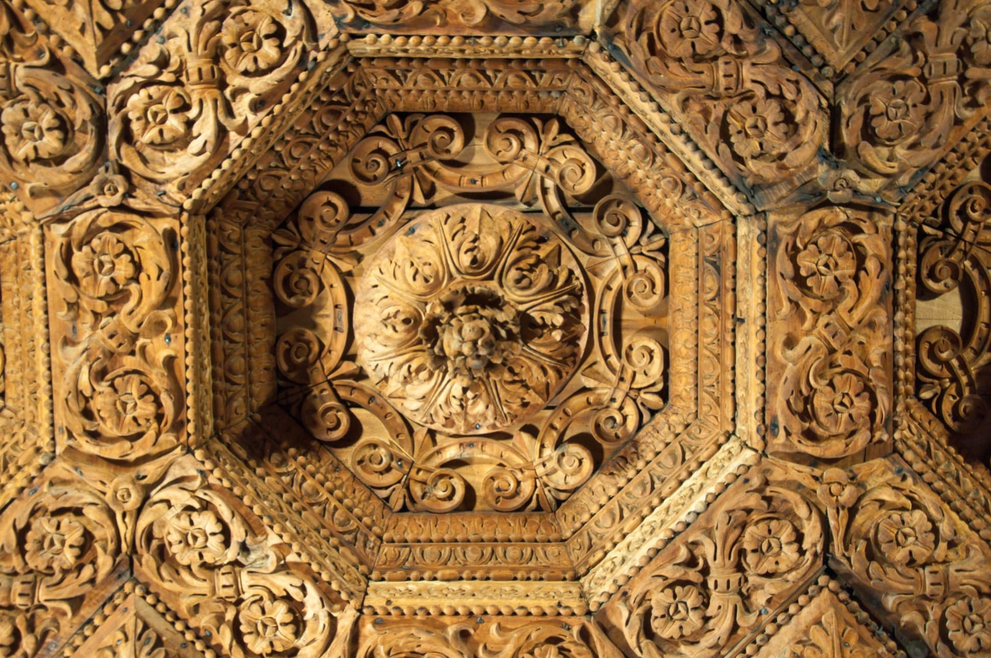 Carved wooden coffered ceiling with octagonal panels, scrolls and a central rosette