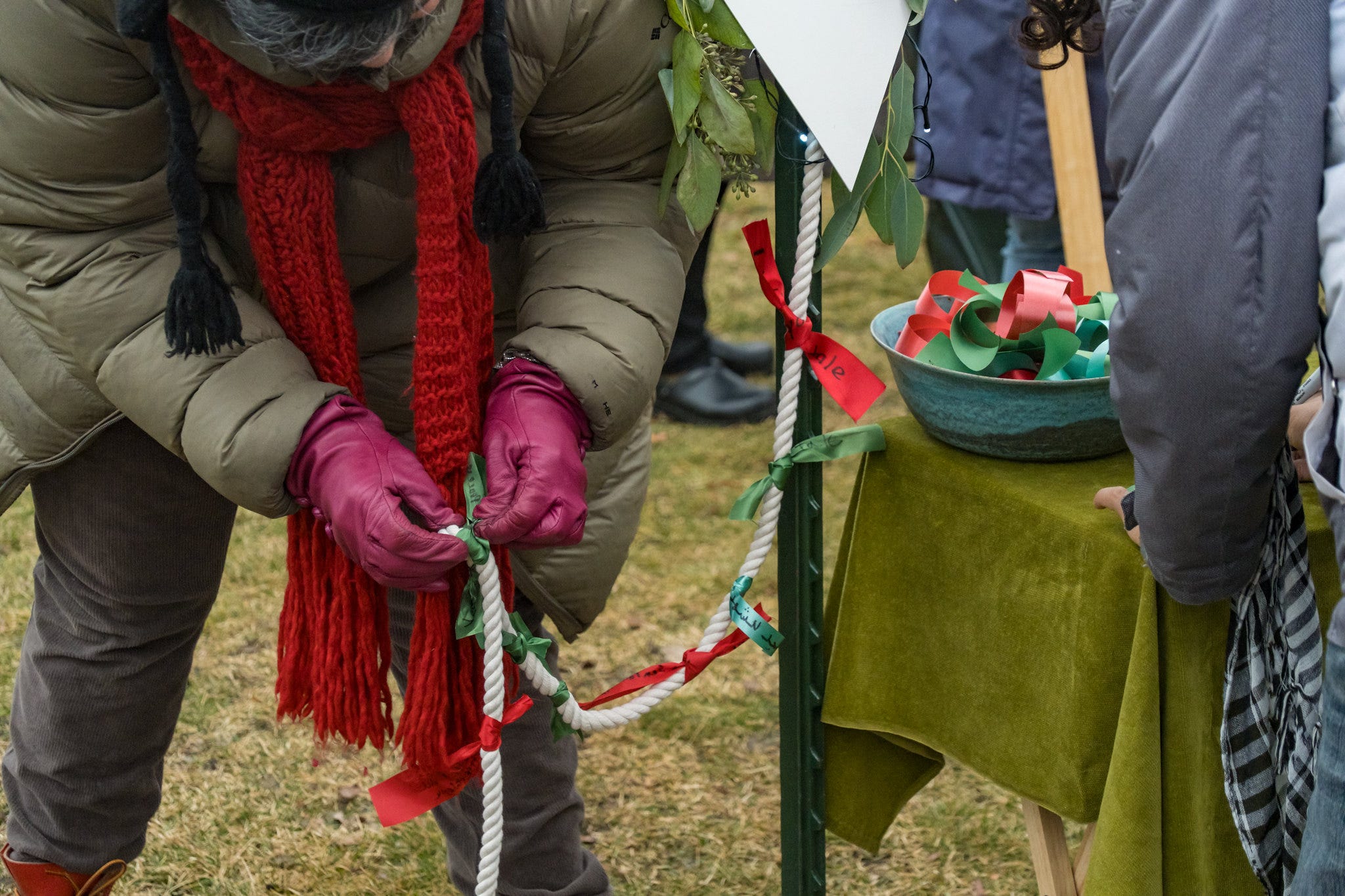 A protester ties messages on ribbons to the take of a kite.