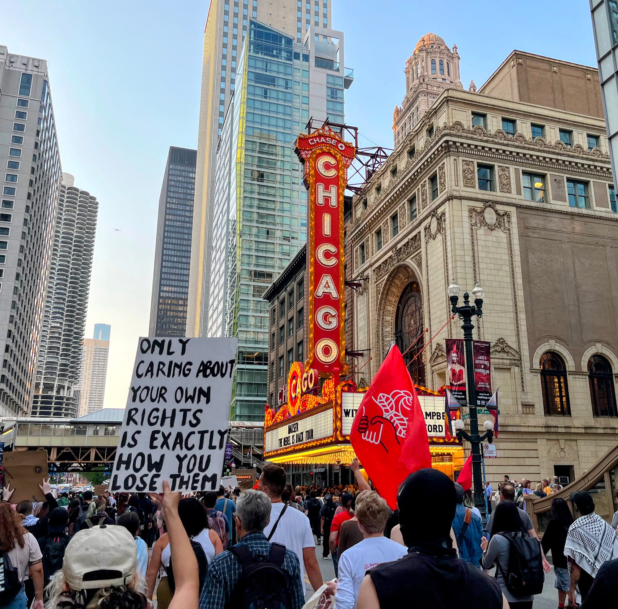 Protesters march past the Chicago Theater.
