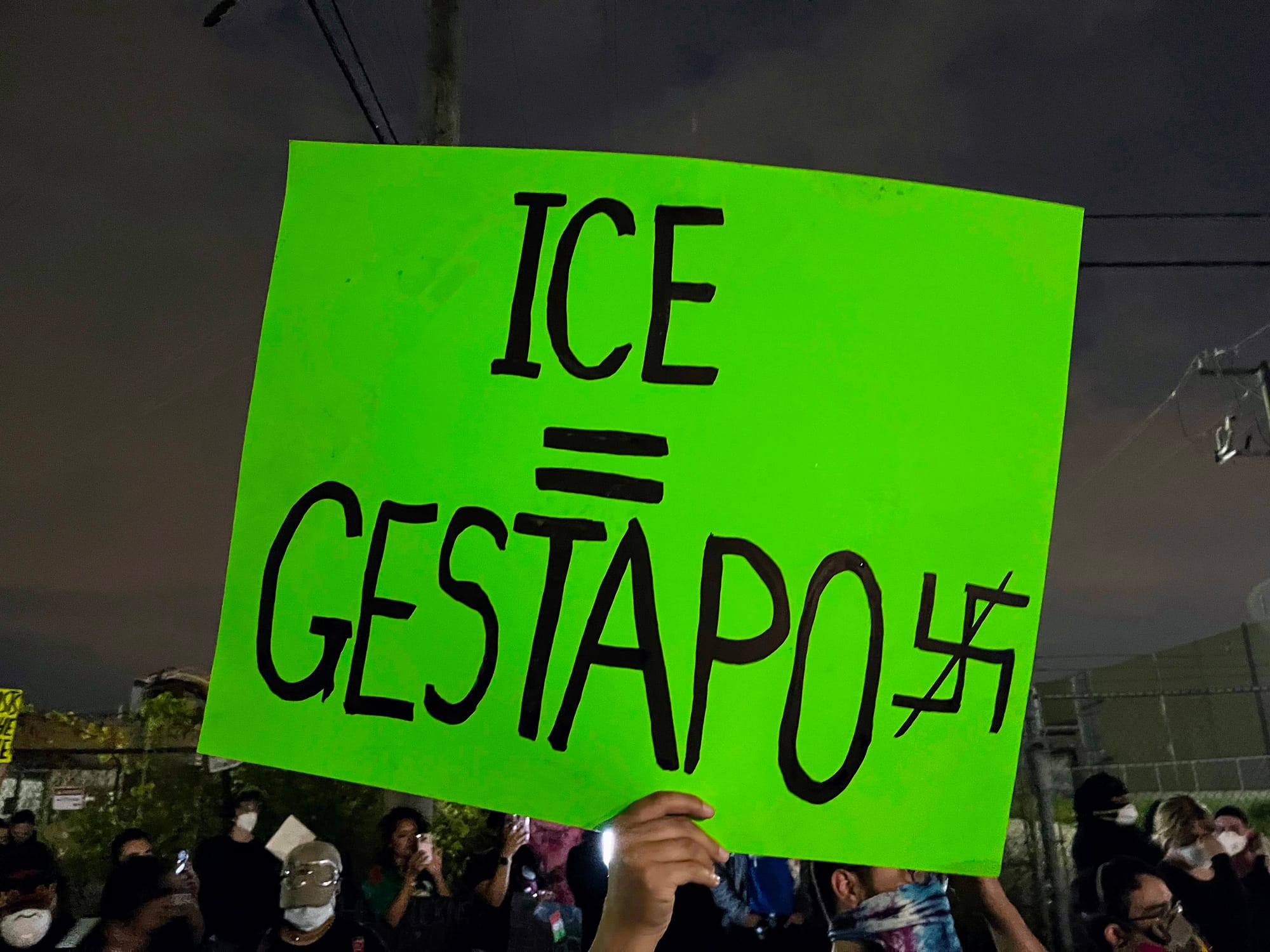 A sign reads "ICE = Gestapo"