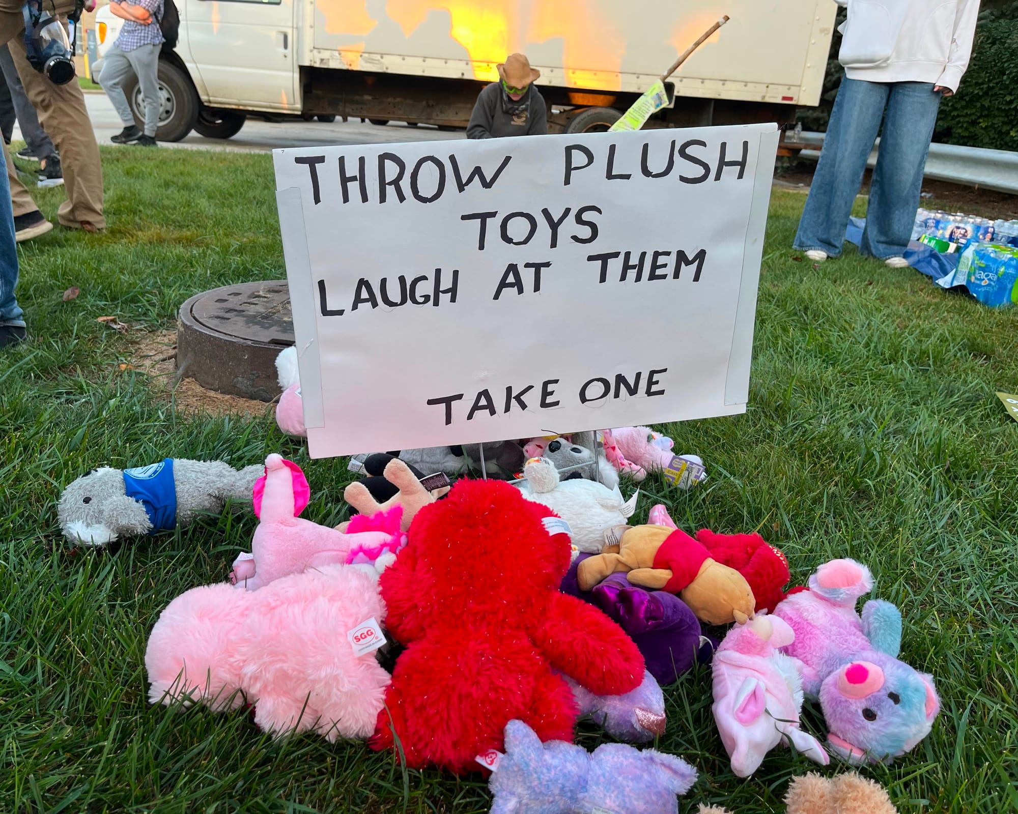 A sign advises protesters to take a stuffed animal and throw it at ICE agents.