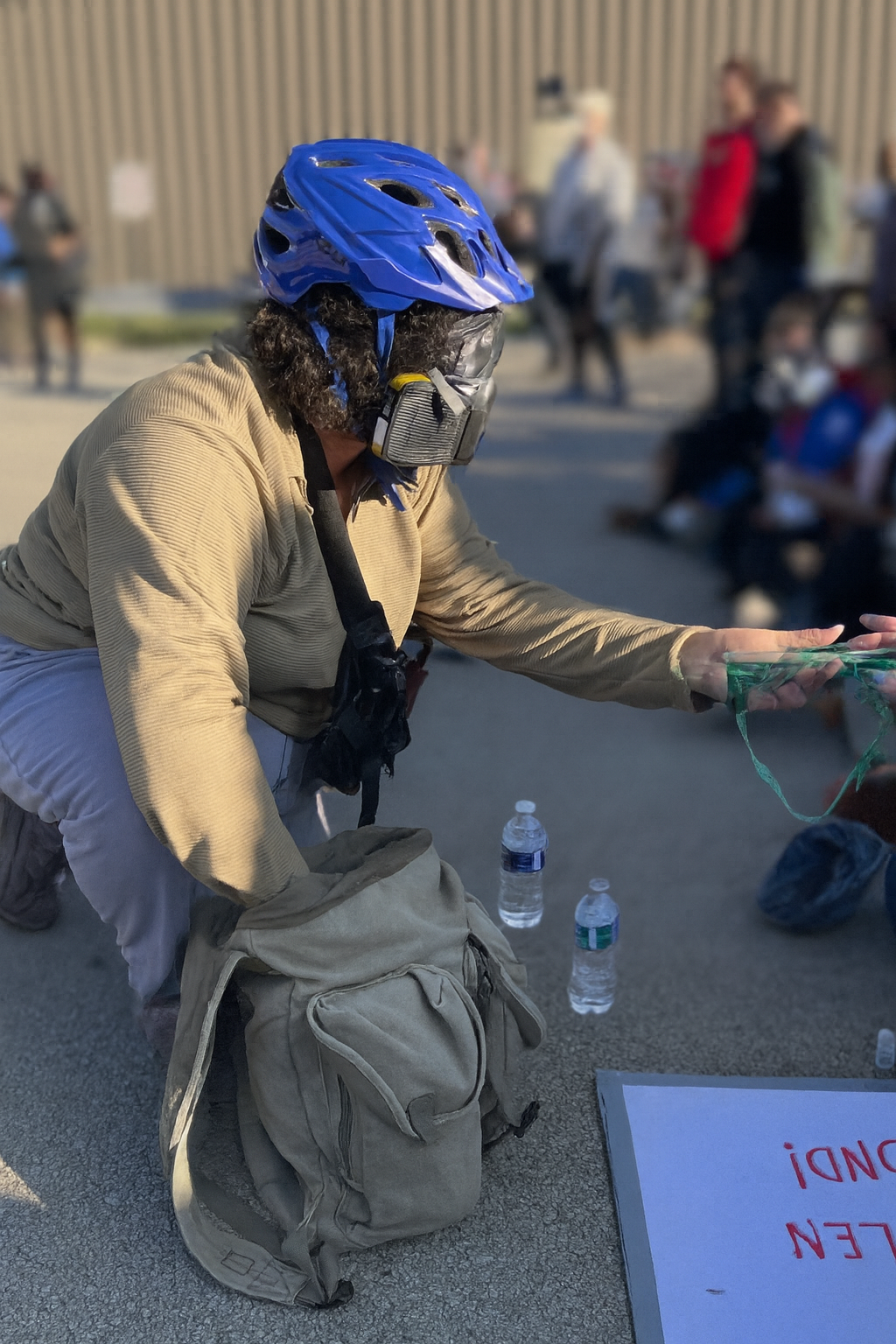 Organizer Kara Rodriguez distributes gas masks and goggles.