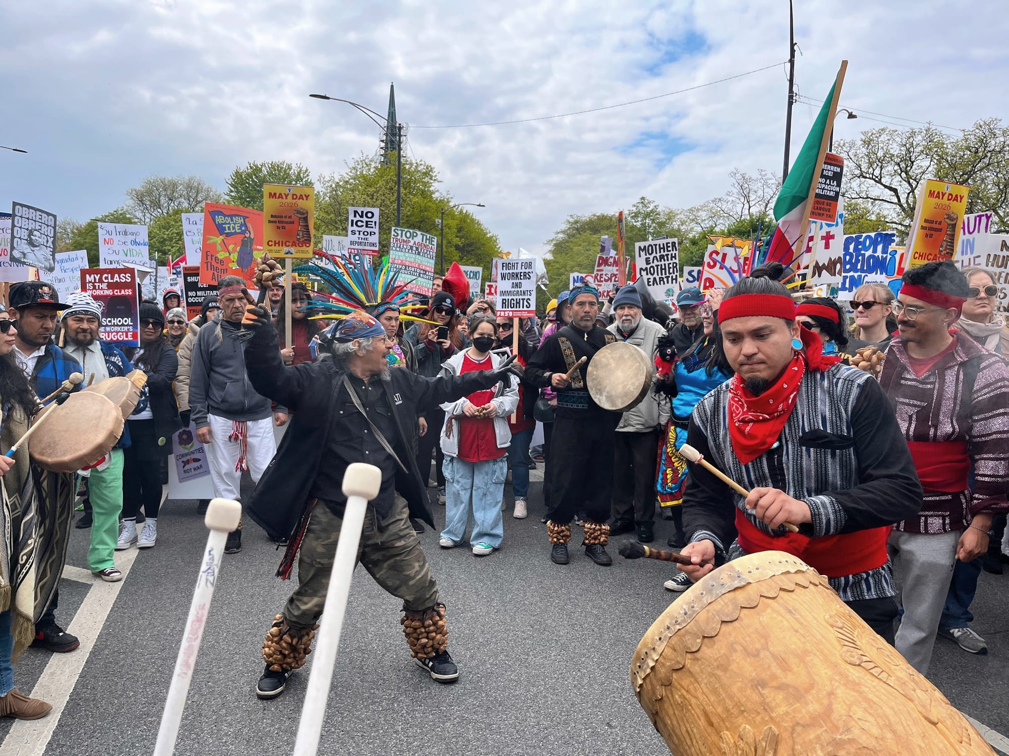 Native protesters drum, dance and march in regalia.