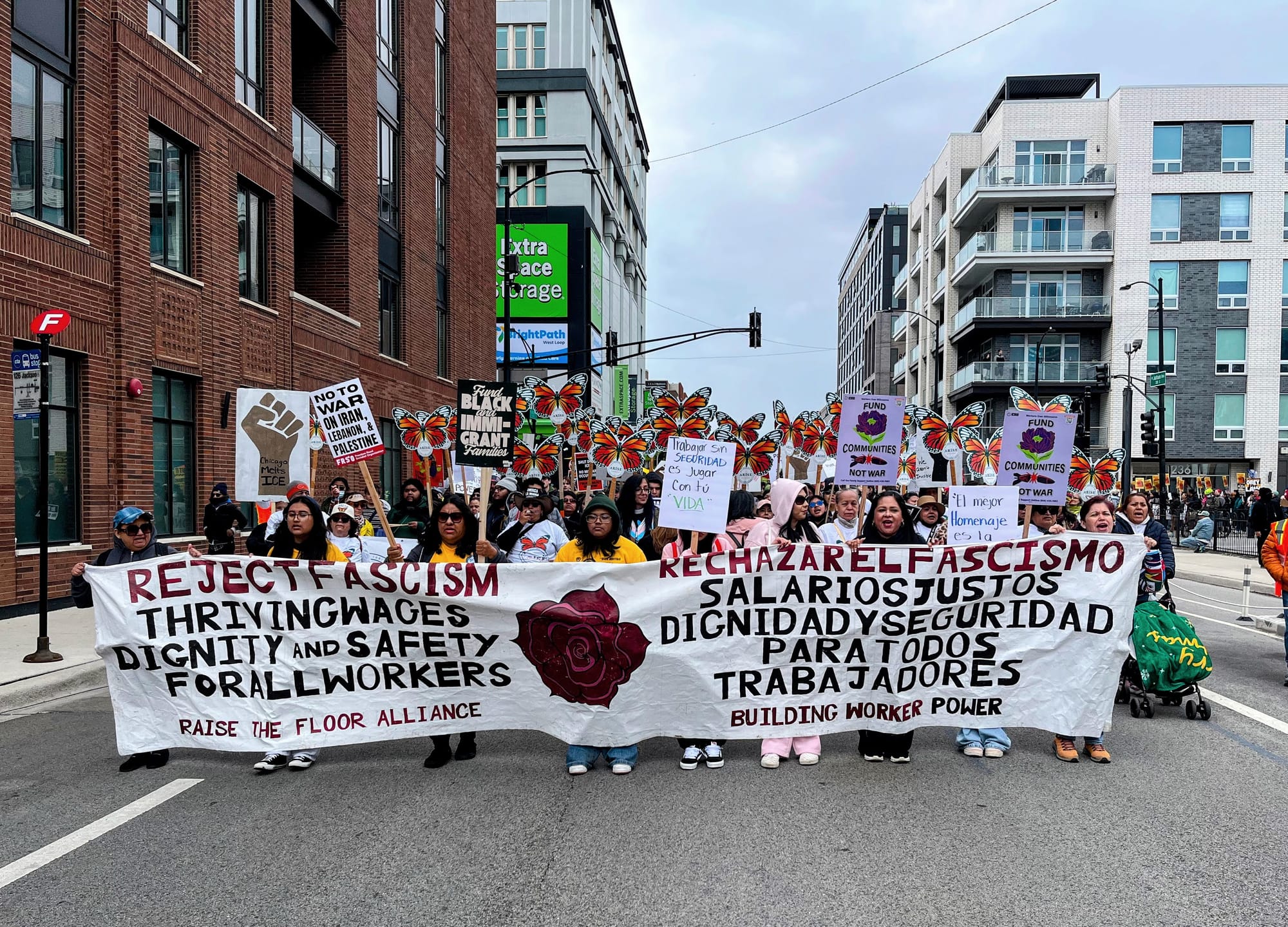 Protesters march with a pro-worker banner denouncing fascism.