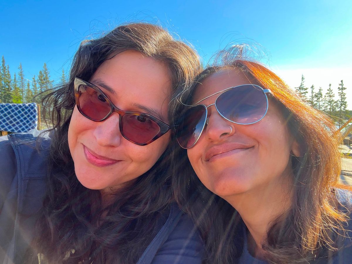 A selfie of Kelly with Harsha Walia in the woods.